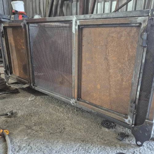 Steel cage before and after protective coating